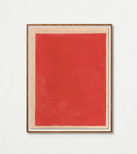 Framed red artwork on a white wall