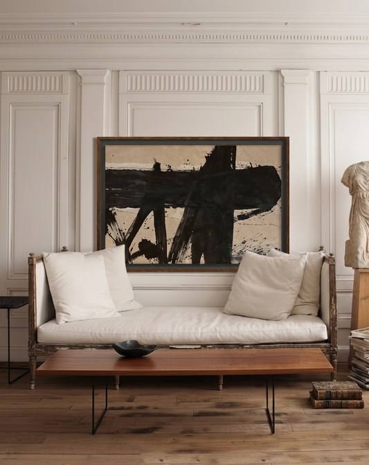 Living room with a sofa, coffee table, and abstract painting on the wall.