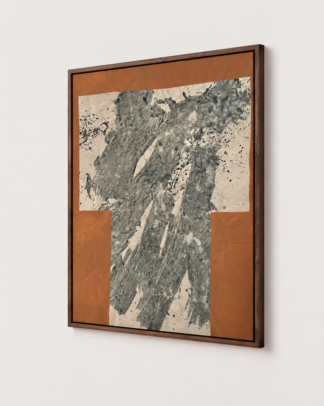 A framed abstract art by Nicolas Makelberge featuring textured charcoal and gray brushstrokes over warm terracotta and cream blocks, enclosed in a dark wood frame and shown hanging on a light wall.