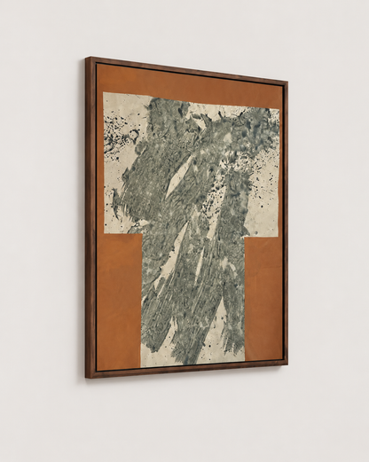 A framed abstract art by Nicolas Makelberge featuring textured gray-green brushstrokes on a cream background, surrounded by a rust-orange border and enclosed in a dark brown wooden frame, shown hanging on a light gray wall.