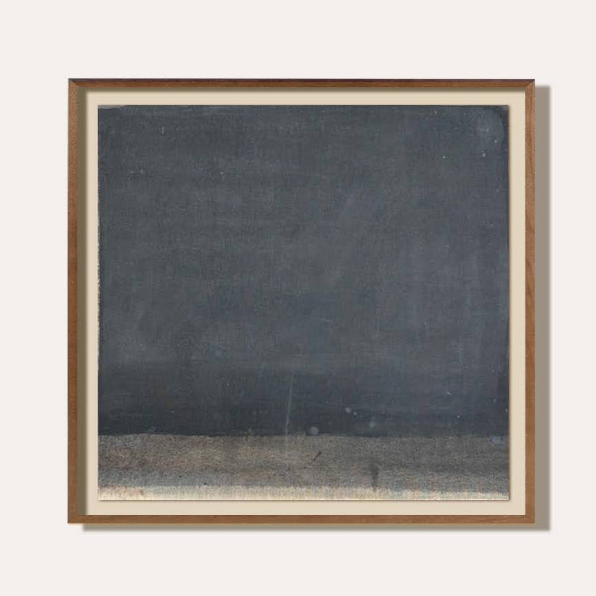 Framed artwork with a dark abstract design on a white background