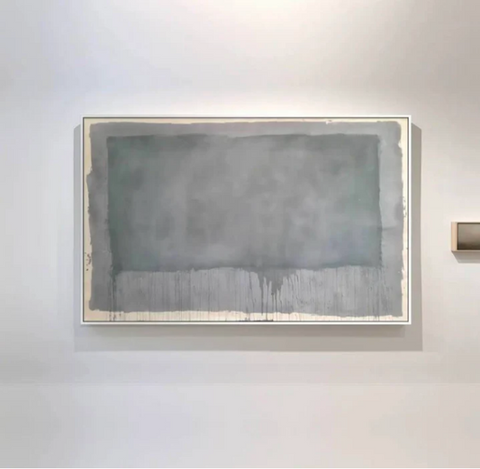A framed artwork featuring shades of gray and teal, mounted under glass.