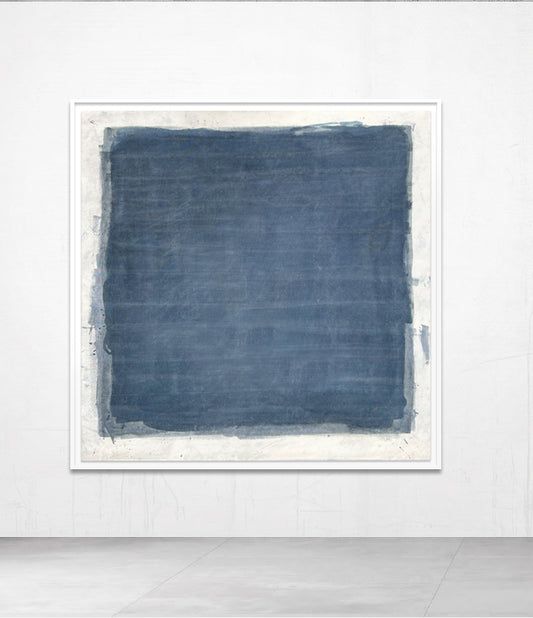 A framed abstract artwork in blue tones, displayed on a wall.