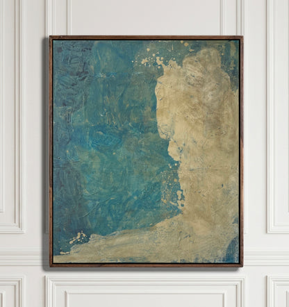 An abstract framed painting featuring textured blue and beige tones, hung on a white paneled wall.