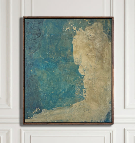 An abstract framed painting featuring textured blue and beige tones, hung on a white paneled wall.