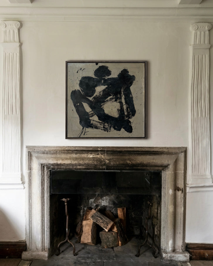 Fireplace with a decorative painting above it on a white wall.