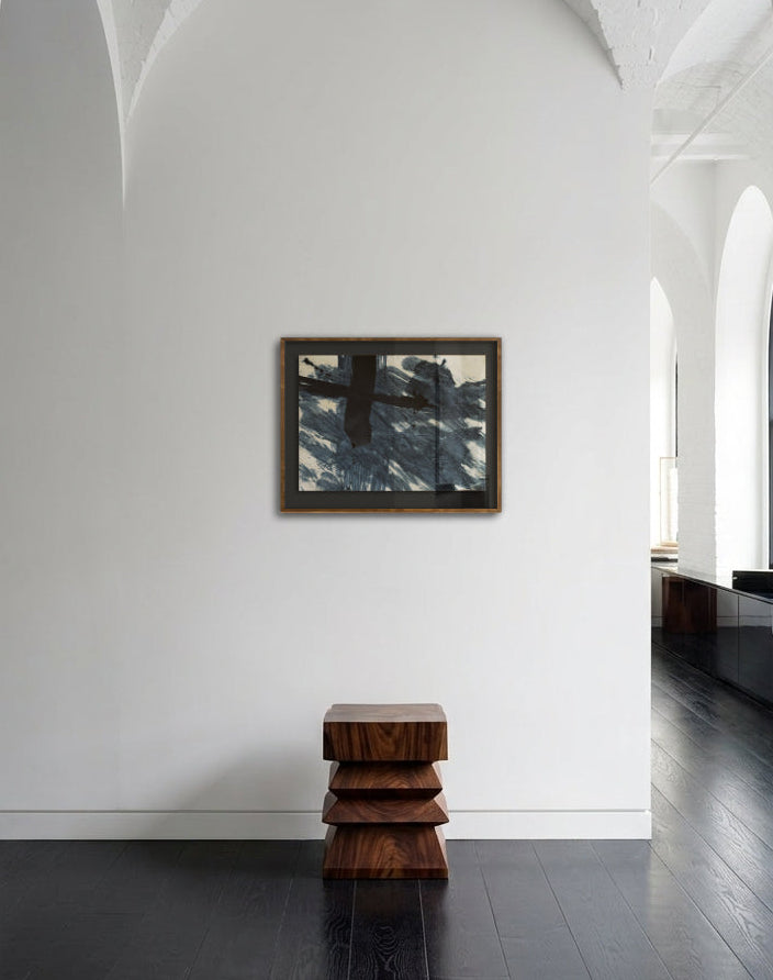 Modern interior with a stack of wooden stools against a white wall with a mirror.
