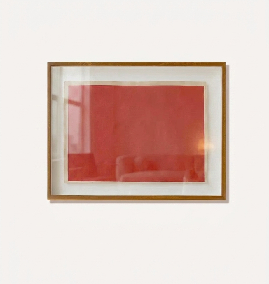 Framed makelberge artwork with a red abstract design on a white background