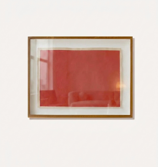 Framed makelberge artwork with a red abstract design on a white background