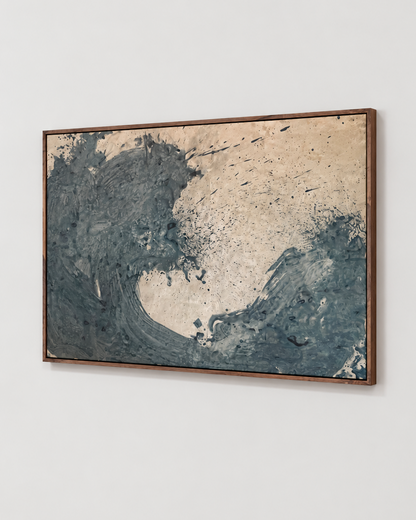 A framed abstract wave painting featuring textured navy blue and beige brushstrokes by Nicolas Makelberge, housed in a dark brown wooden frame and displayed on a light gray wall.