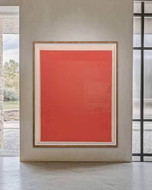 Red abstract painting in a modern interior setting with large windows.