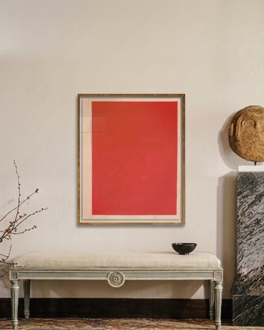 Elegant interior with a red abstract painting, marble column, and decorative bench.