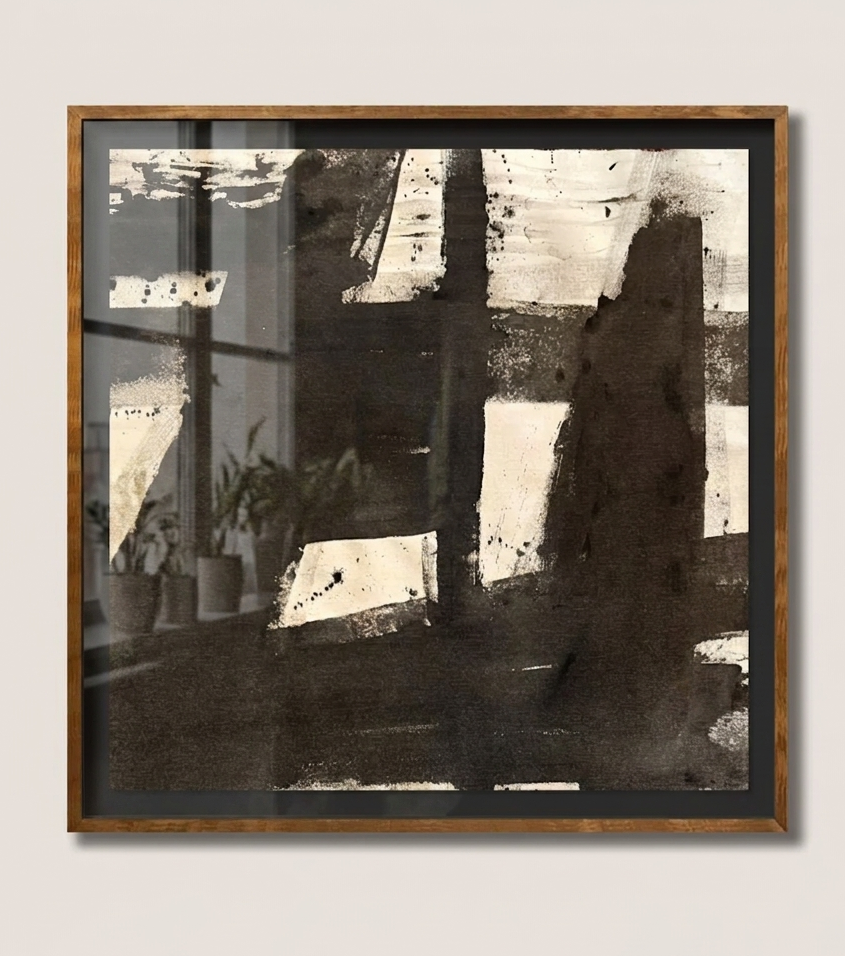Framed abstract makelberge art piece on a white wall