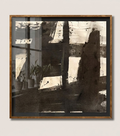 Framed abstract makelberge art piece on a white wall