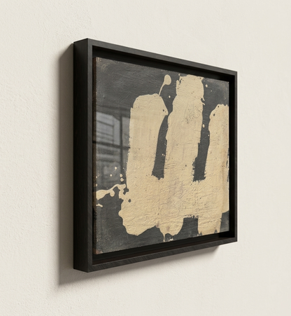 Abstract art piece by makelberge with black and beige colors in a black frame on a light wall.
