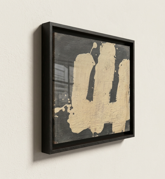 Abstract art piece by makelberge with black and beige colors in a black frame on a light wall.