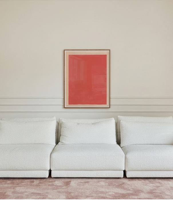 White sofa in a room with a red abstract painting on the wall.