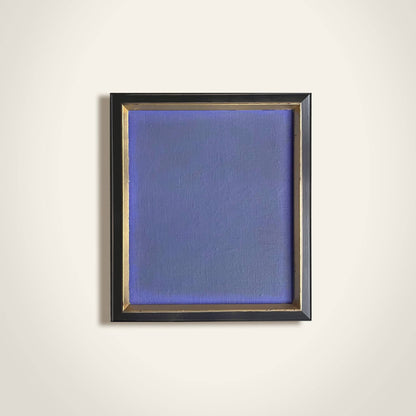 Framed abstract painting with a blue textured canvas on a white wall