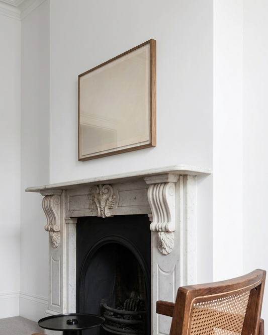 Decorative fireplace with a mirror above it in a room with a chair.